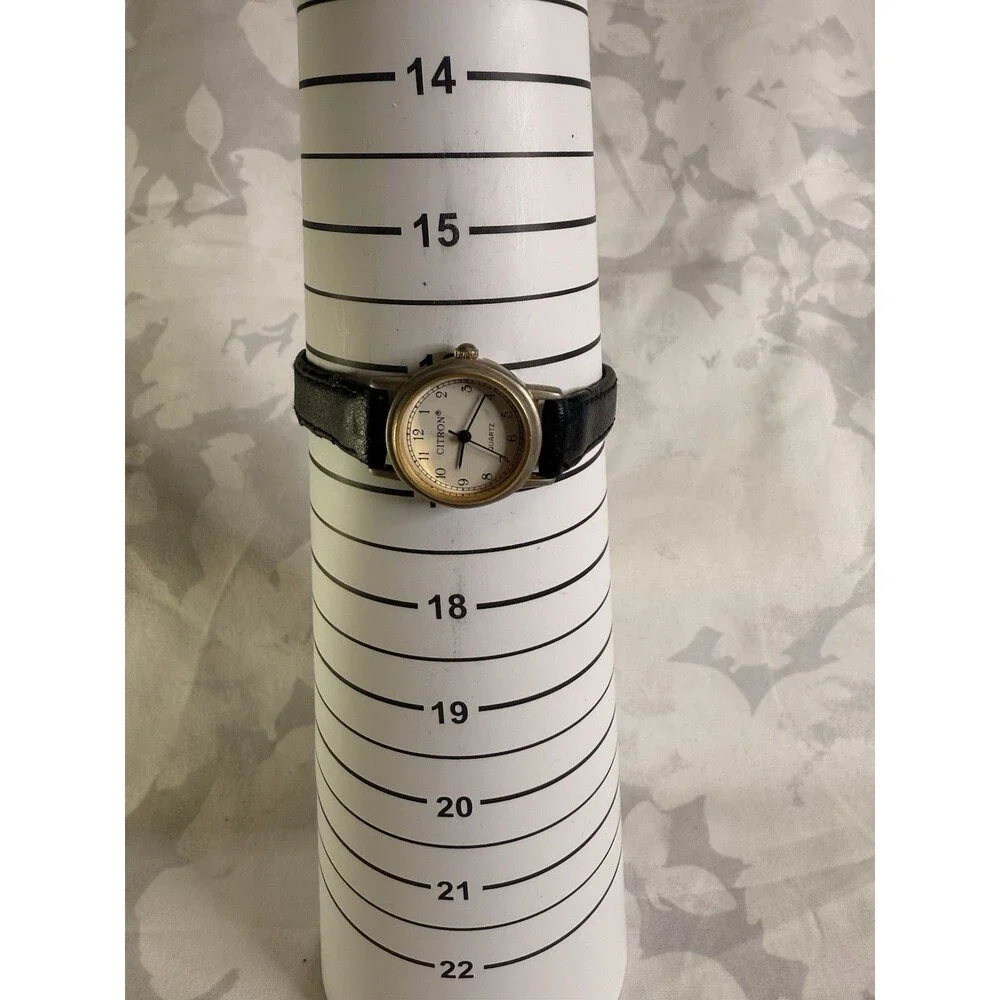 Citron Vintage Women’s Watch, White dial and gold casing. Black leather band.
